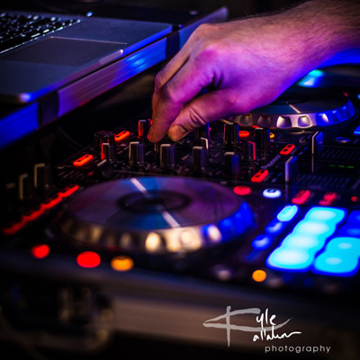 A picture of James from Hayward Sound making adjustments at his music control panel